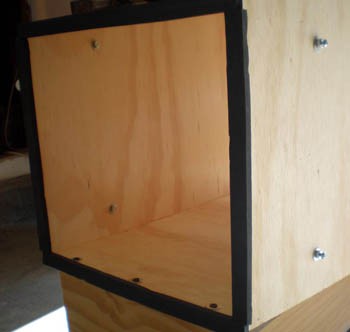 Rubber gaskets cover the edges and corners of a wooden box