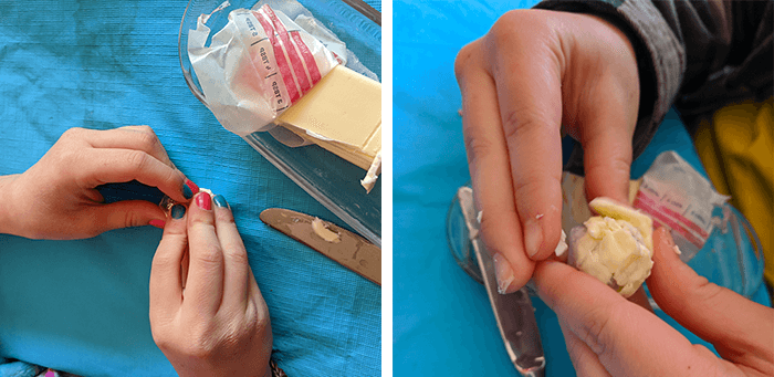 Student pressing butter onto the aluminum foil ball