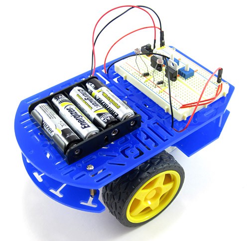 An assembled chassis with a breadboard and battery pack for a light-following robot