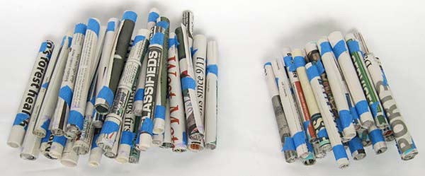 Two piles of newspaper tubes of different lengths