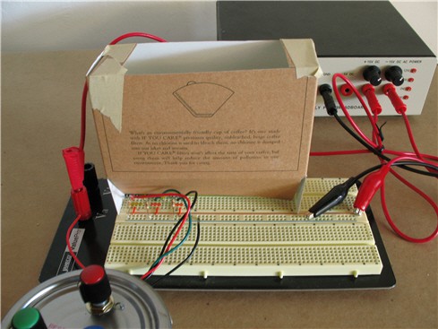 An open topped cardboard box is placed on a breadboard