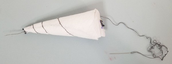 Double-threaded backstitch spiraled around unicorn horn. 