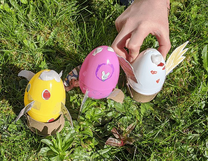 Row of three plastic Easter eggs that have been filled and set in place as rockets