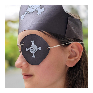 Girl wearing eyepatch and pirate hat for a vision science experiment - Pirate-themed Make-Believe STEM Science Experiments