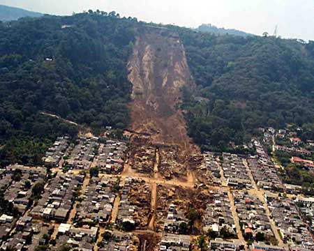 Aerial photo of a landslide that has buried blocks of houses in the town of Colonia Las Colinas