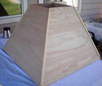 Wooden corner guards are stapled to the corners of a contraction cone where the side panels meet