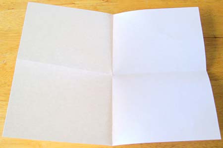 Crease lines on a sheet of paper separate it into four quadrants