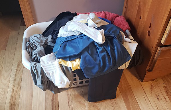 A pile of dirty laundry in a basket