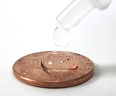 Water is dropped onto the surface of a penny