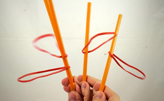 Rubber bands are spun around a pencil