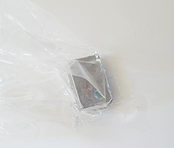 A neodymium magnet inside a plastic bag