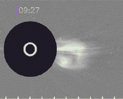 A coronagraph shows a large white flare emerging from the surface of the Sun with a timestamp of 9:27