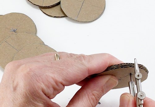  The sharp point of a compass piercing a stack of 2 well-aligned circles.  
