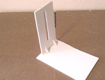 Two pieces of foamboard mounted at a right angle with a slot cut through the center of the shorter side