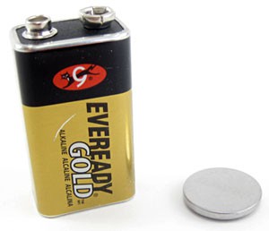 A nine volt battery next to a coin cell battery