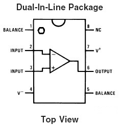 Diagram of a rectangular dual-inline package has four pins on either side and a semi-circle cut into the top edge