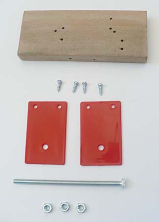 A wooden block, four screws, a long bolt, two plastic panels, and three nuts