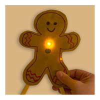 Gingerbread person made from a paper bag with a copper tape circuit and an LED that lights up - Educator's Corner Gingerbread STEM Experiments