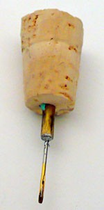 Needle stuck into a cork
