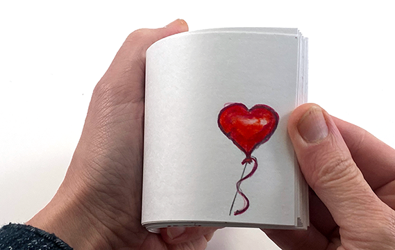 Flip book made from index cards with a heart balloon illustration