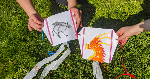 Homemade kites, one of which has a dragon design
