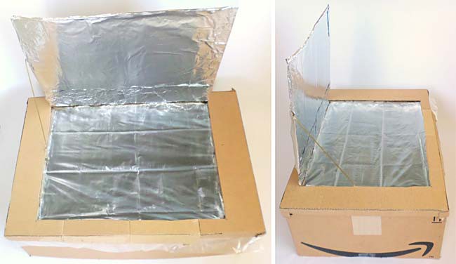 Top-down view of a completed solar oven with its lid flap opened