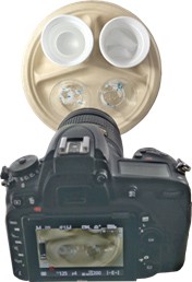 Photo of a camera pointed at four cups on a plate