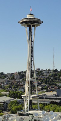 the space needle, a tall skinny tower with a hollow frame and circular observation deck at the top
