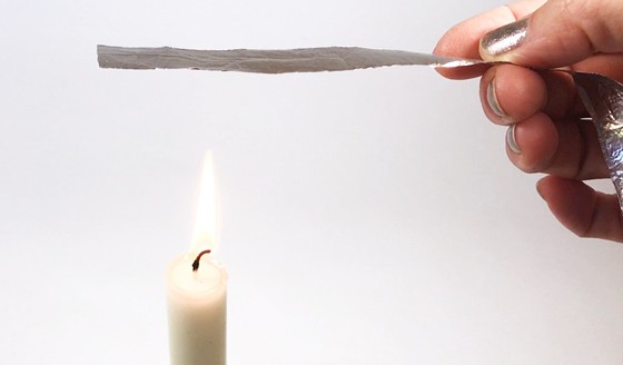 Aluminum strip held about 2 inches above a candle flame.