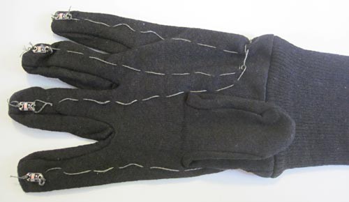 Conductive thread sewn into an LED glove