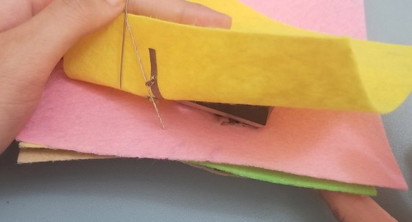 Connecting negative pin on tinylily to conductive fabric tape rail on LED patch. 