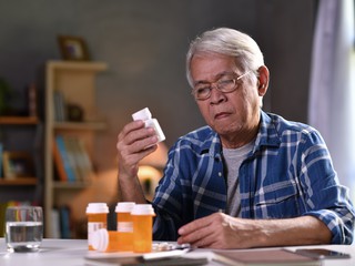 man reading pill label