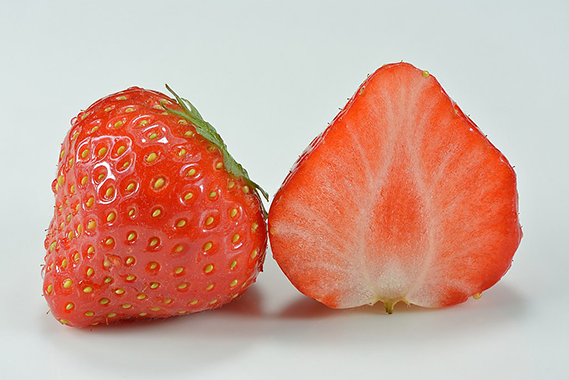 Full strawberry and cut strawberry