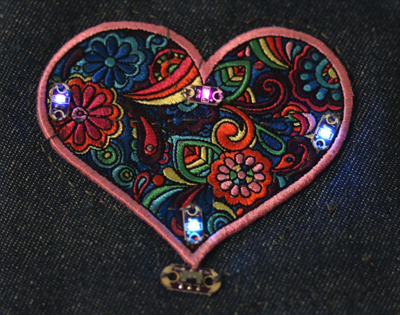 Four LilyPad LEDs sewn onto a heart shaped patch