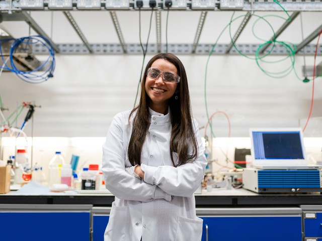 young woman standing in front of a laboratory bench
