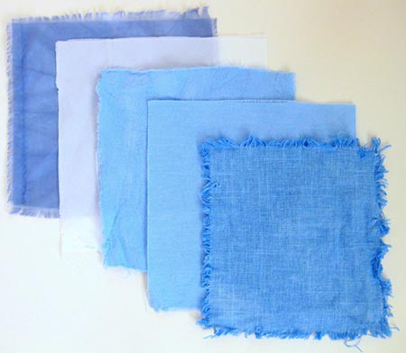 Five squares of fabric dyed different shades of blue