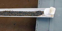 A rain gutter filled with gravel