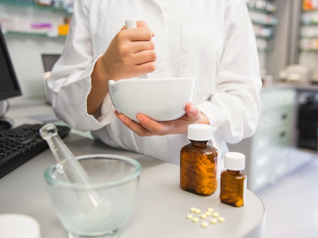 pharmacist mixing medicine