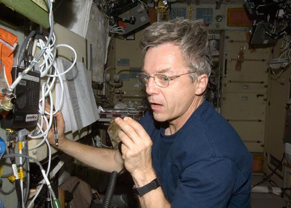 A man on the International Space Station using a radio
