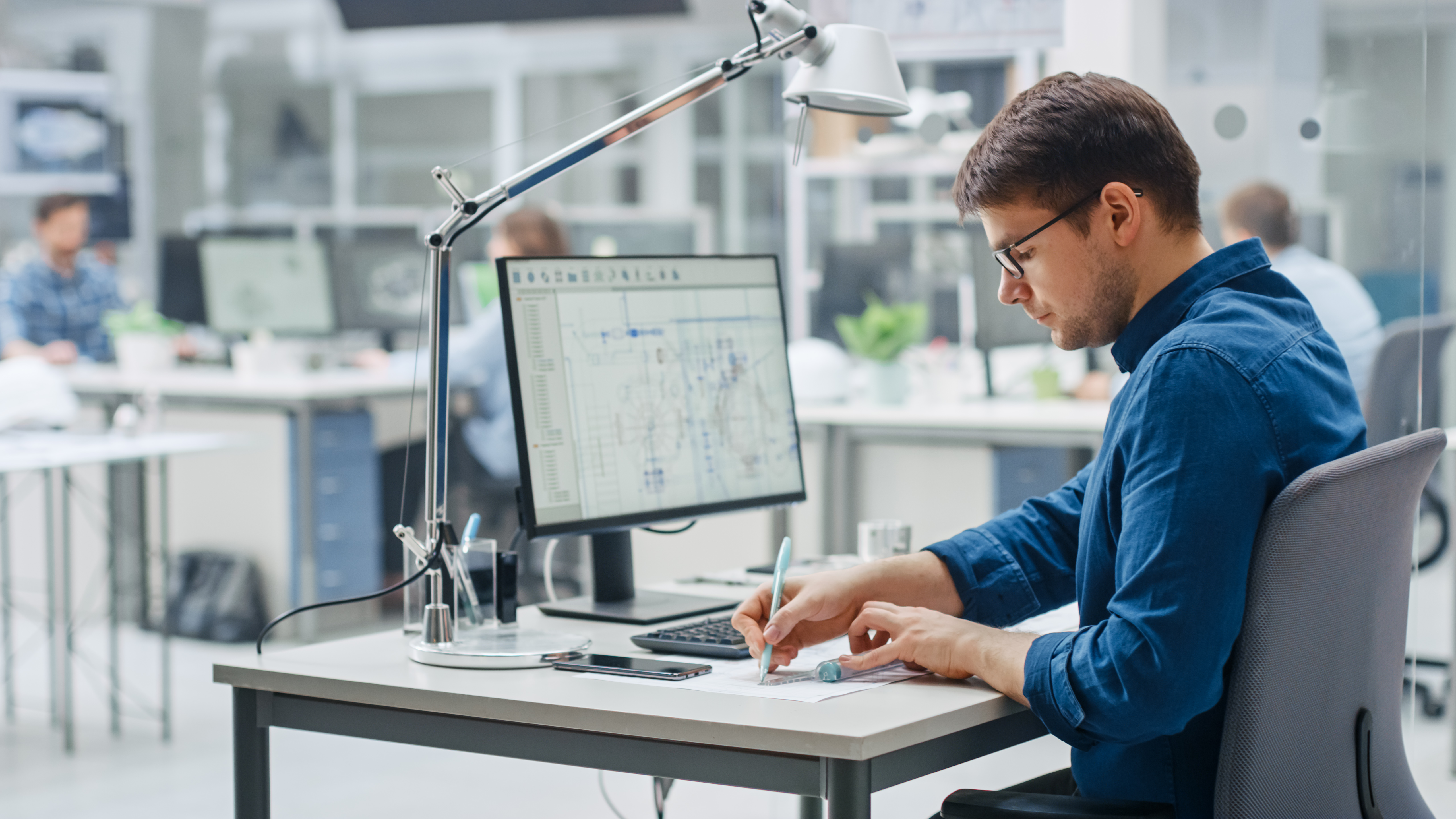 CAD technician working at computer