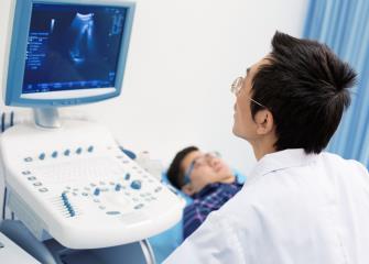 cardiovascular technician attaching electrodes for EKG