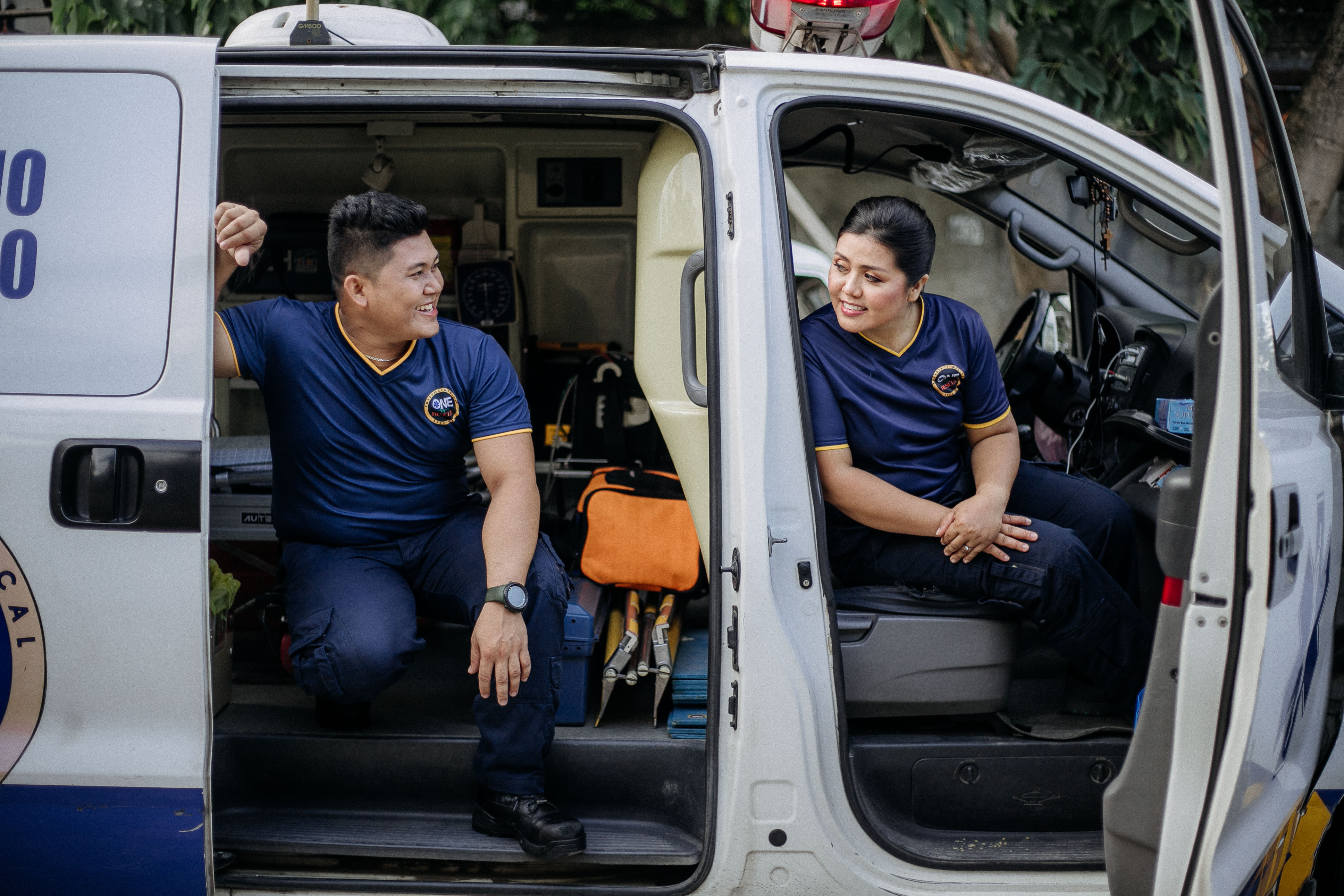 EMT helping patient inside ambulance
