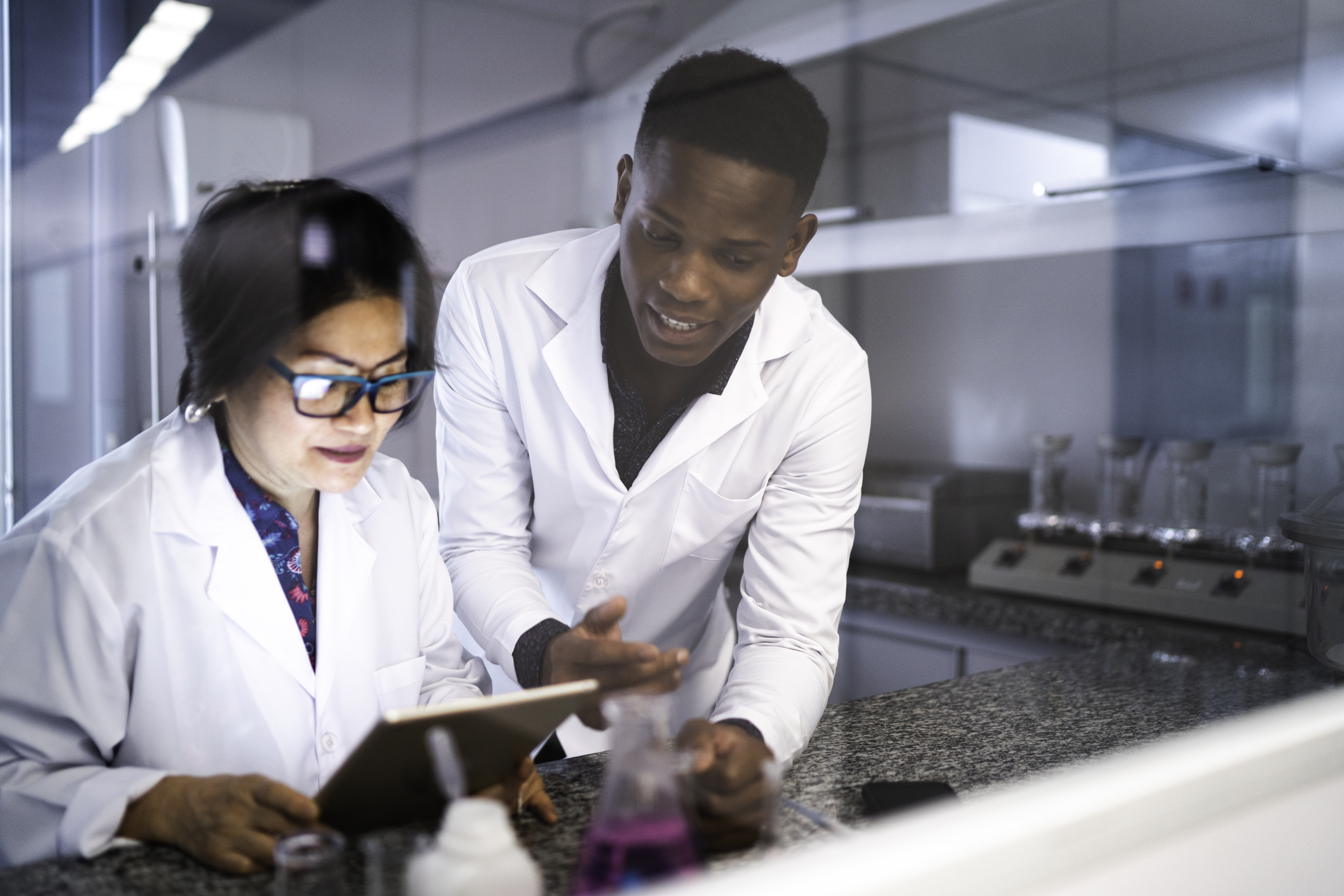 natural sciences manager reviewing trace data with young scientist