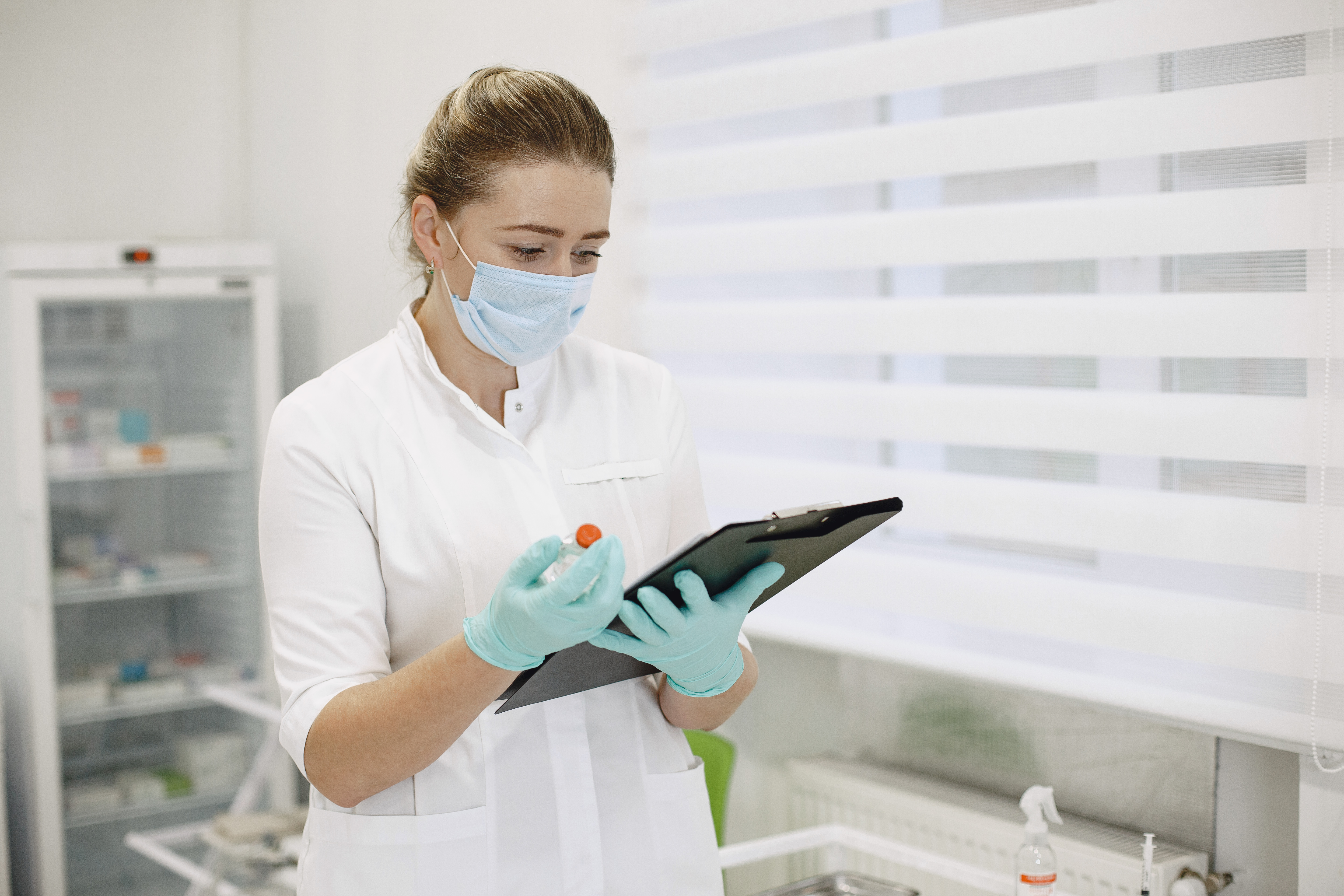 female pharmacist cataloging medications
