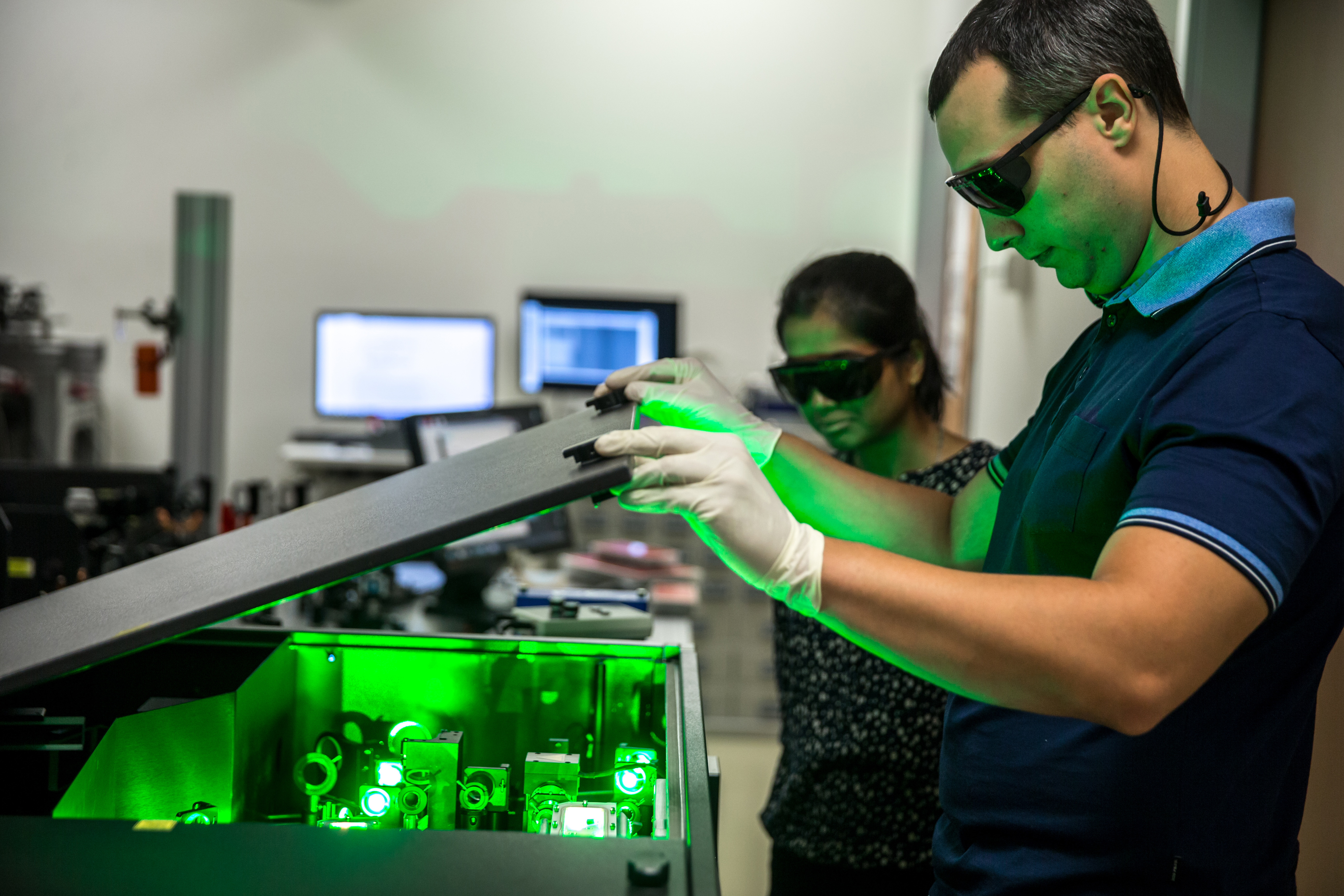 photonics engineer adjusting equipment