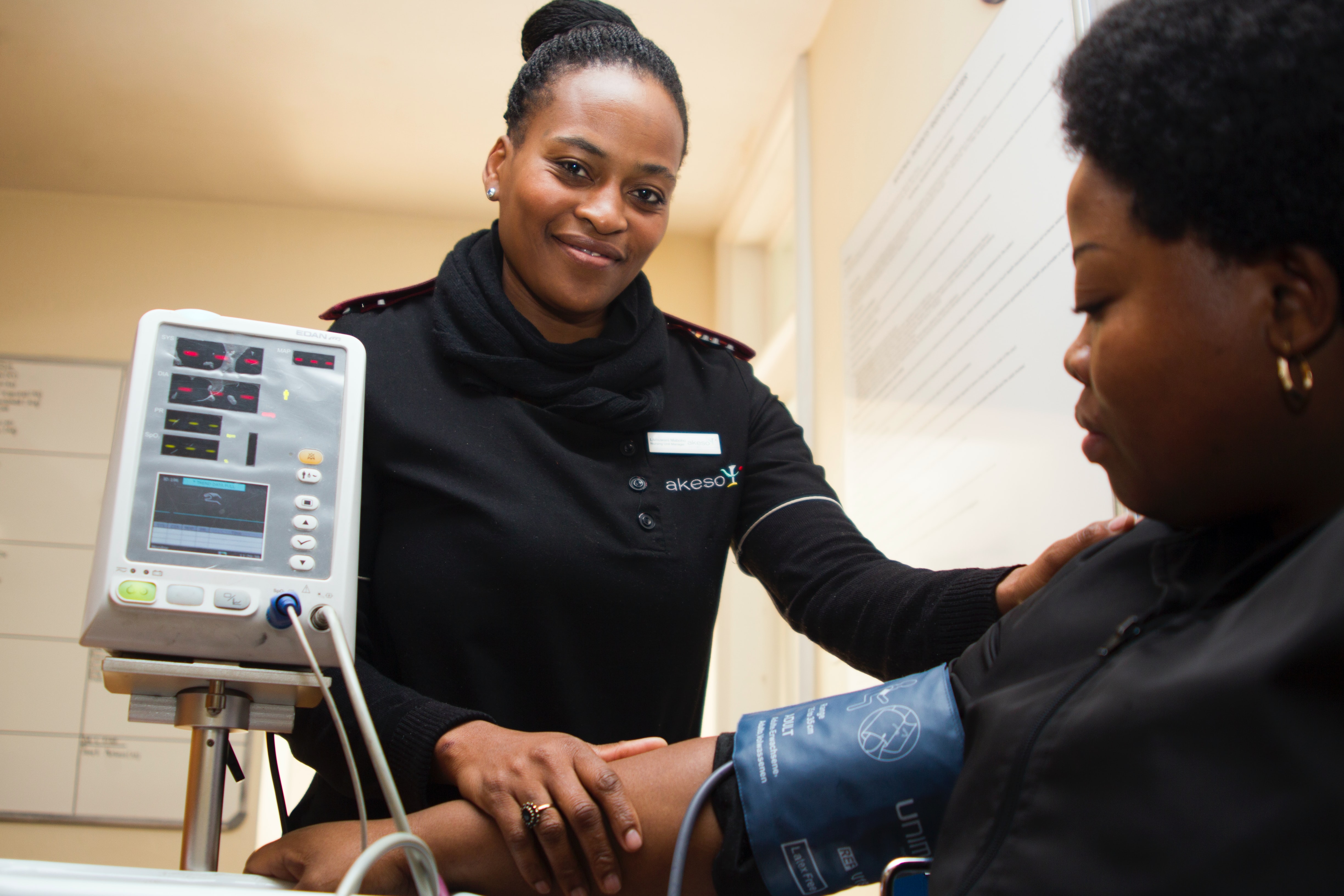 male nurse checking elderly woman's pulse