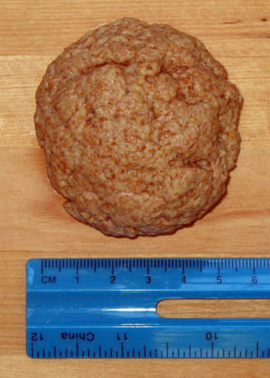 This photo shows a ball of gluten resulting from the extraction process being measured with a ruler.