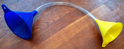 Plastic tubing connects two funnels in the first homemade stethoscope design.