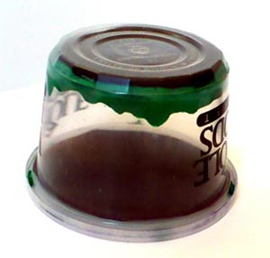 Physics science project Picture of a cloud chamber ready to use, with the cup turned upside down, the felt held in place by the clay on the inside bottom of the cup, and the circle of black construction paper fitting inside the lid of the cup.