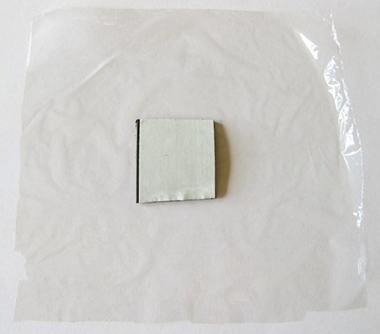 Human Biology science project Picture of a magnet tape square on a piece of plastic wrap.